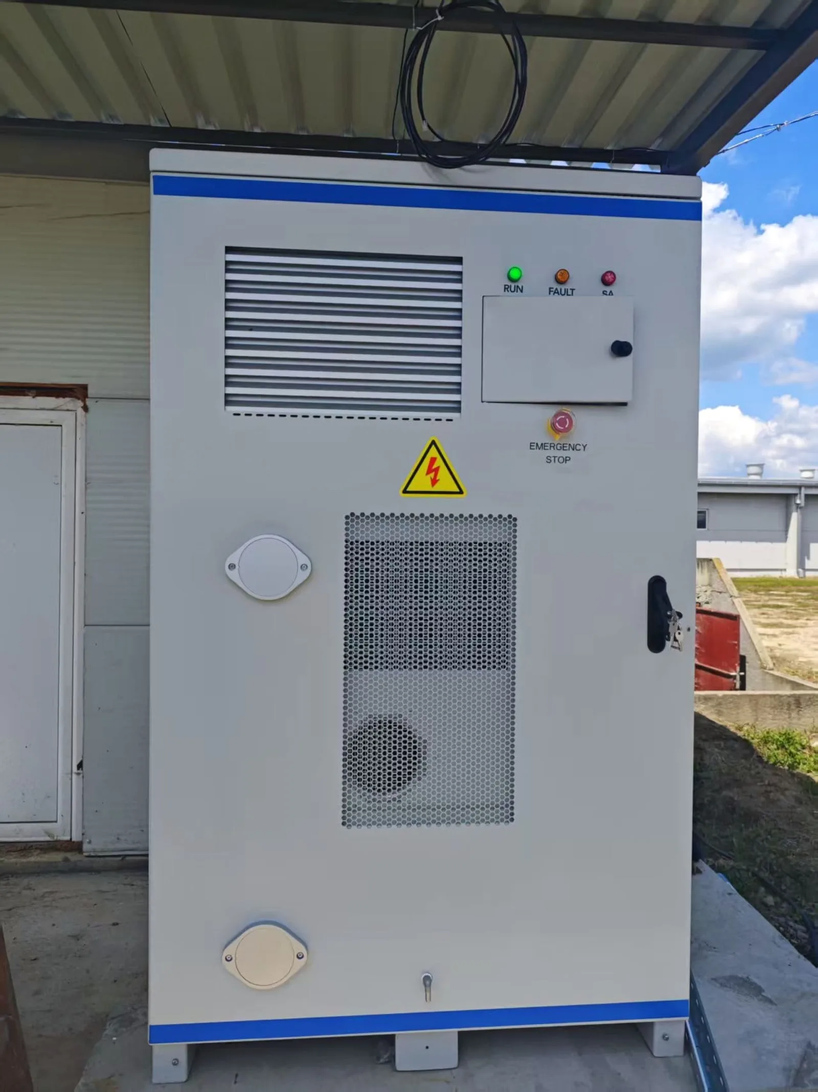 Gros plan sur l'armoire HC60P-100B montrant les indicateurs d'état et l'arrêt d'urgence